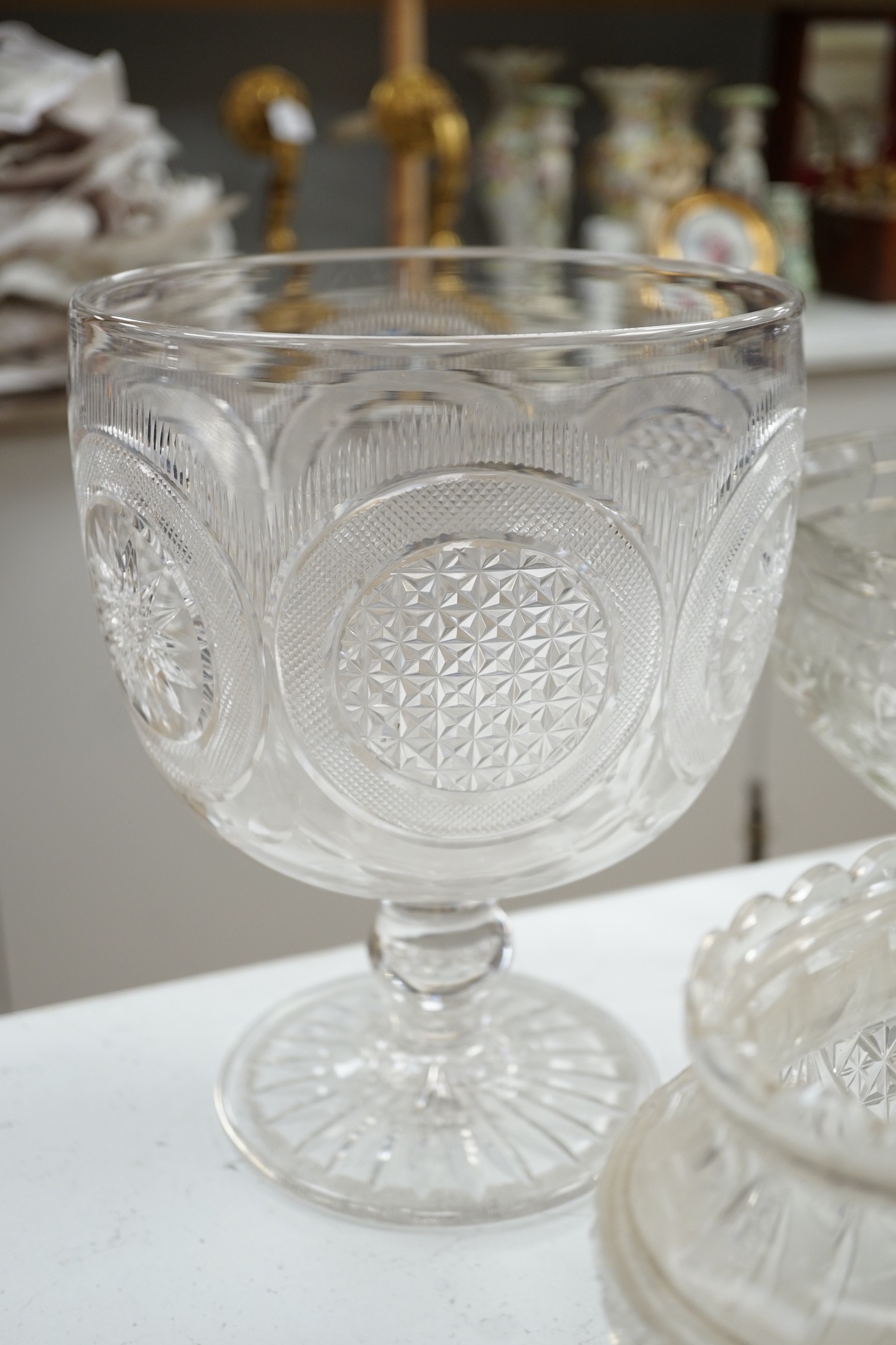 An early 20th century oval cut glass bowl on gilt metal stand, a pair of slice cut decanters and stoppers, a blown glass smoke bell two bowls and four other items of glassware, tallest 26 cm